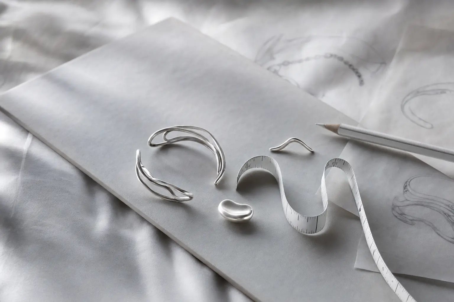 Cool gray planning still life with a silver sample and vellum sketches