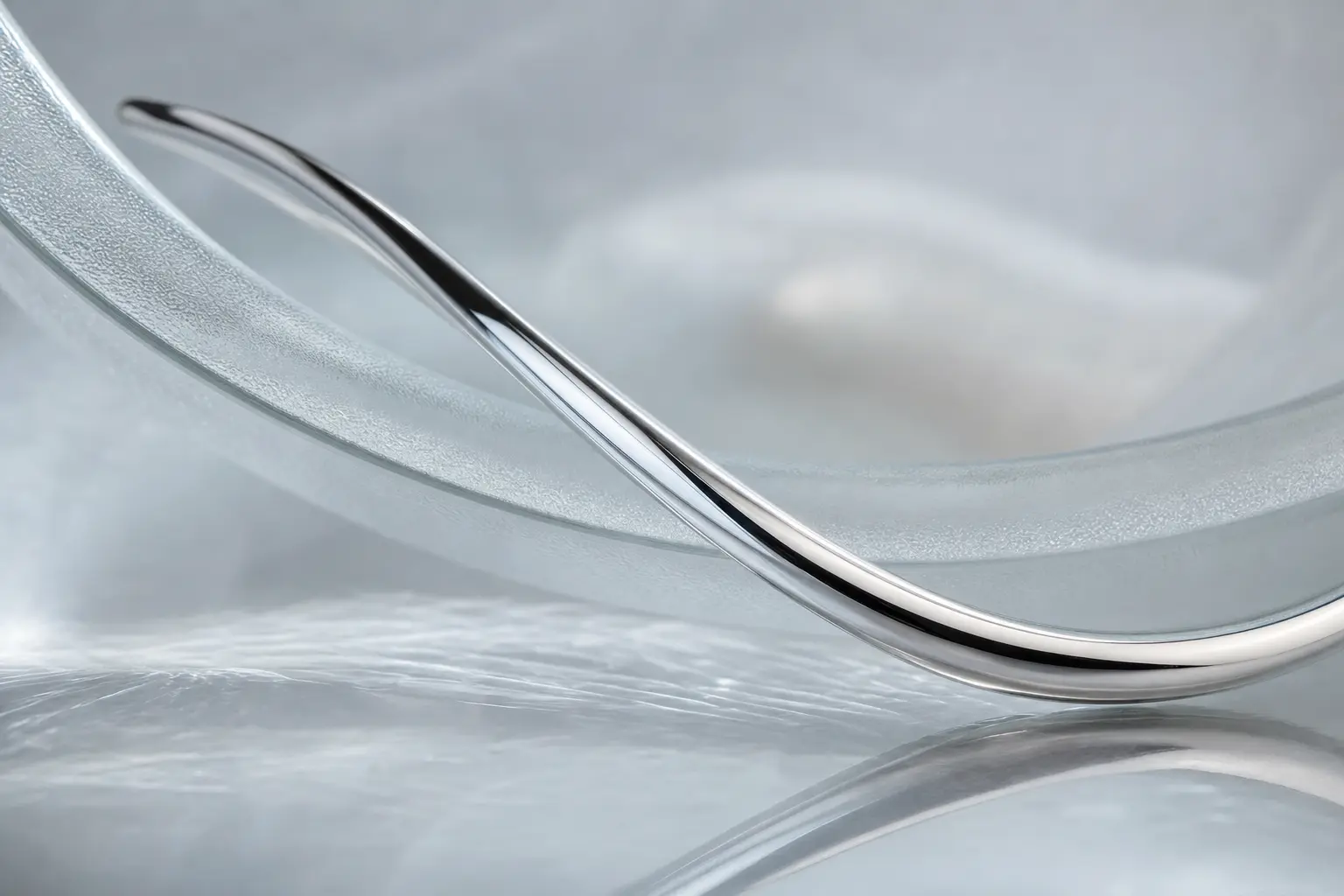 Polished silver curve echoing a frosted glass edge