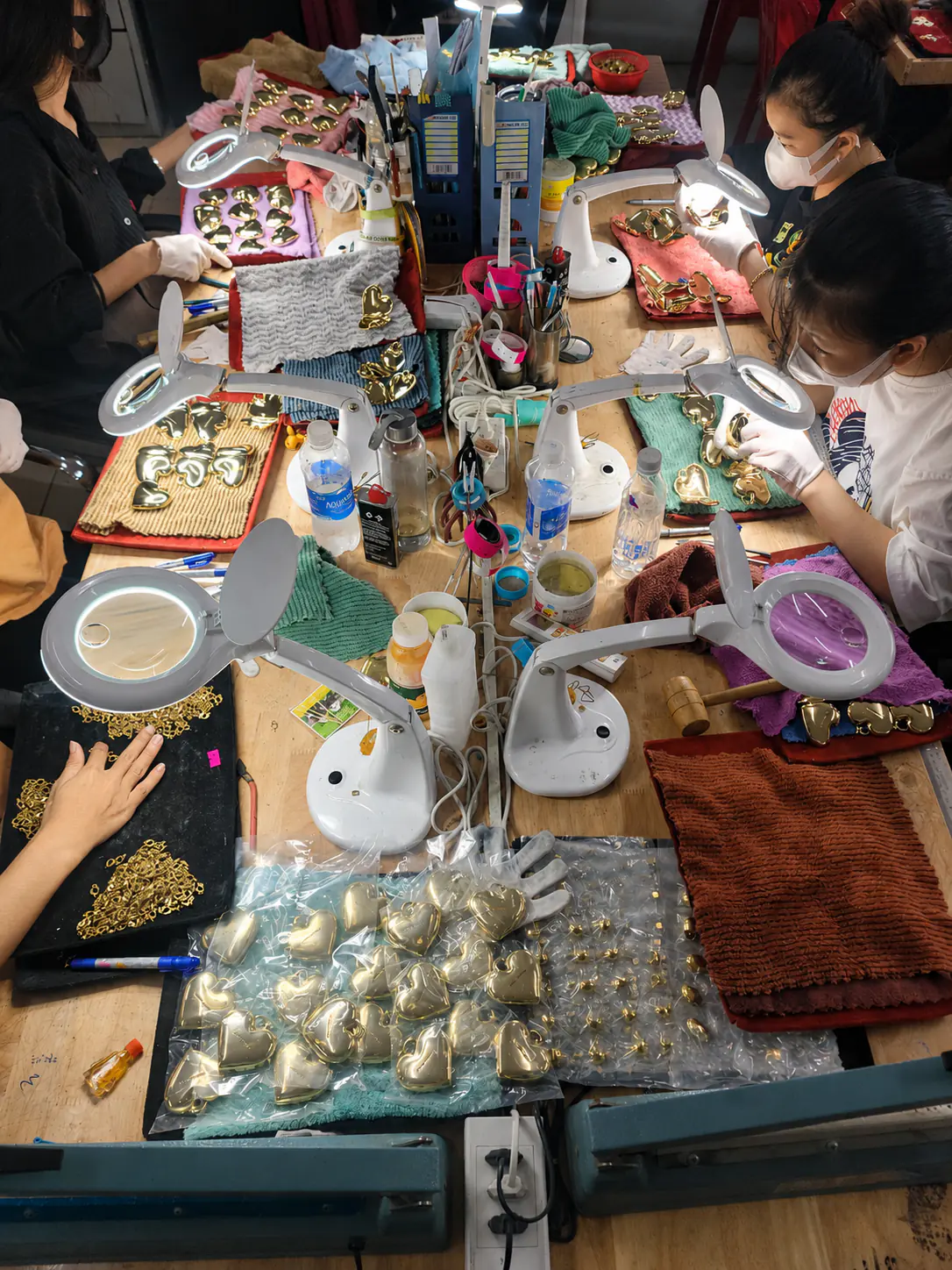 Jewelry production floor with operators and manufacturing equipment